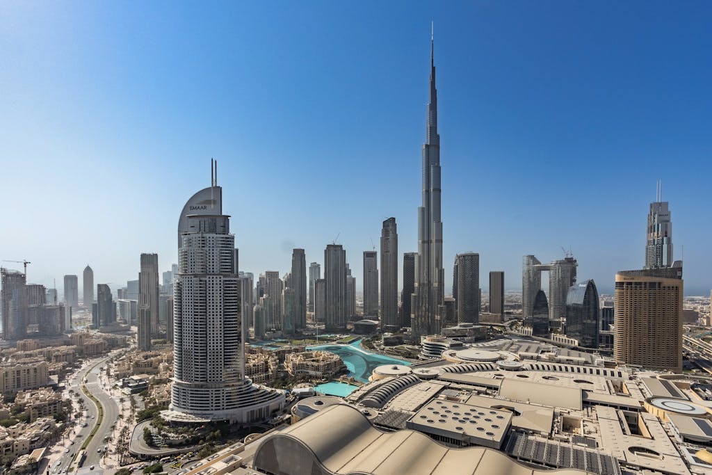 Stunning aerial view of Dubai's modern skyline featuring the iconic Burj Khalifa under a clear blue sky.